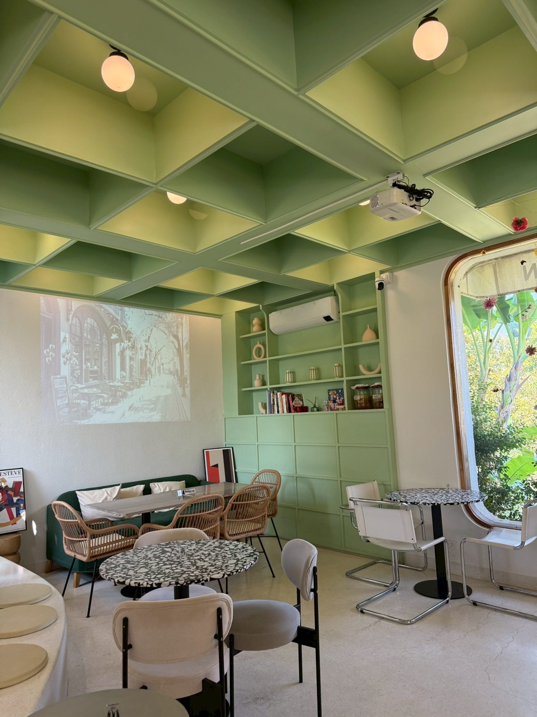 The mint green interior with projector wall